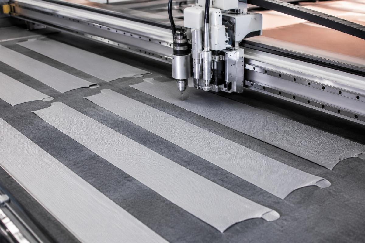 Production line of curtain and blinds components being cut with a CNC oscillating knife machine