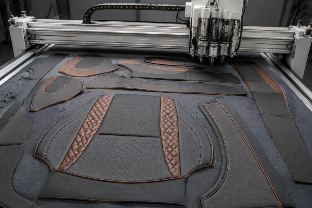 Finished car seat cover blanks cut by a CNC oscillating knife machine laid out for inspection